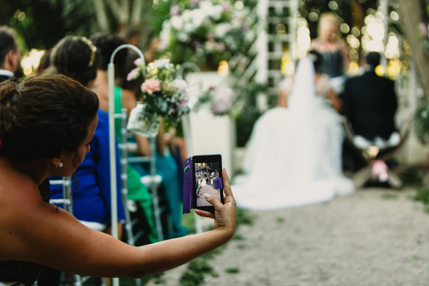 Woman Takes Mobile Photo of Wedding